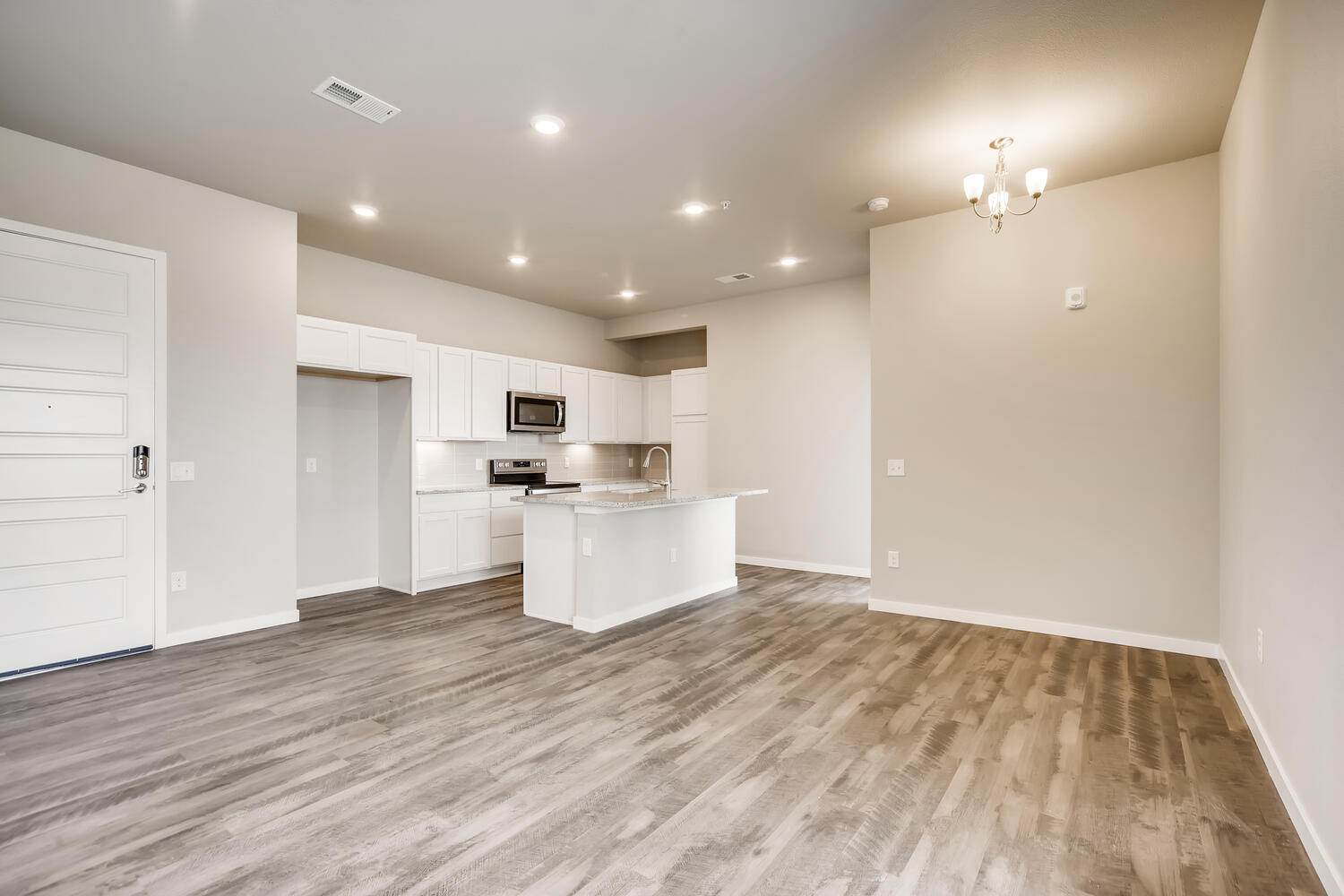 A kitchen with white cabinets.