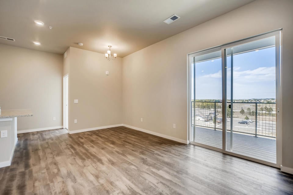 A room with a wood floor and a glass door.