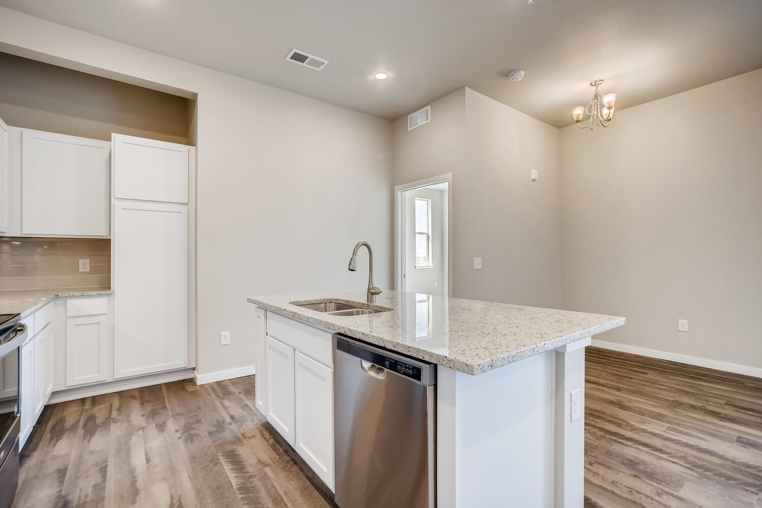 A kitchen with white cabinets.