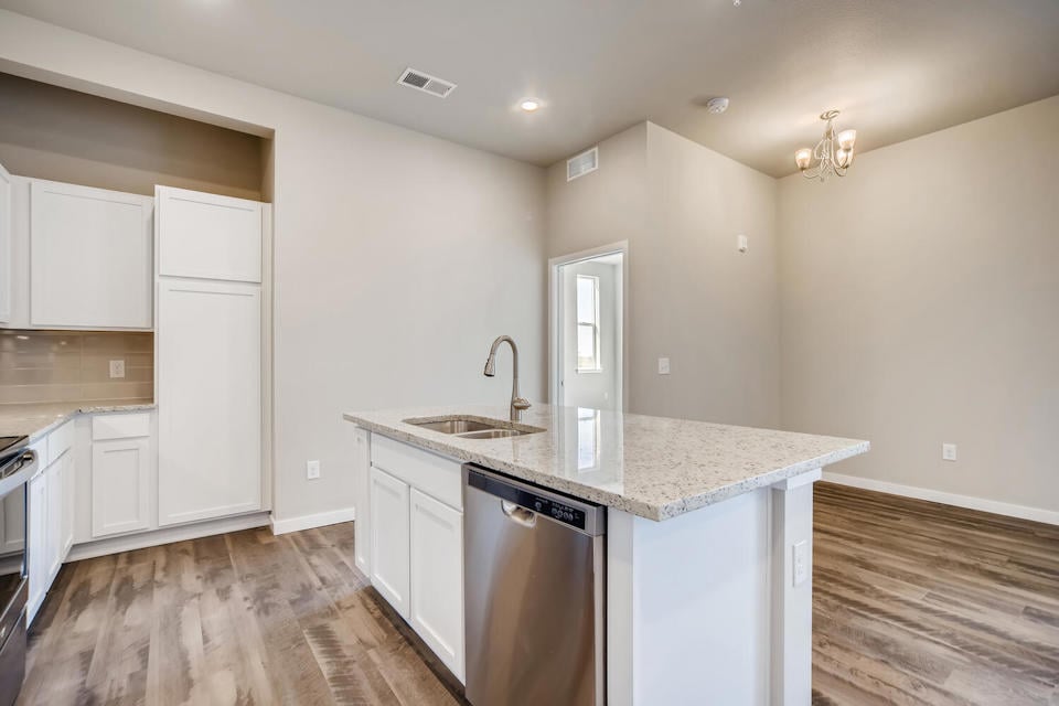 A kitchen with white cabinets.