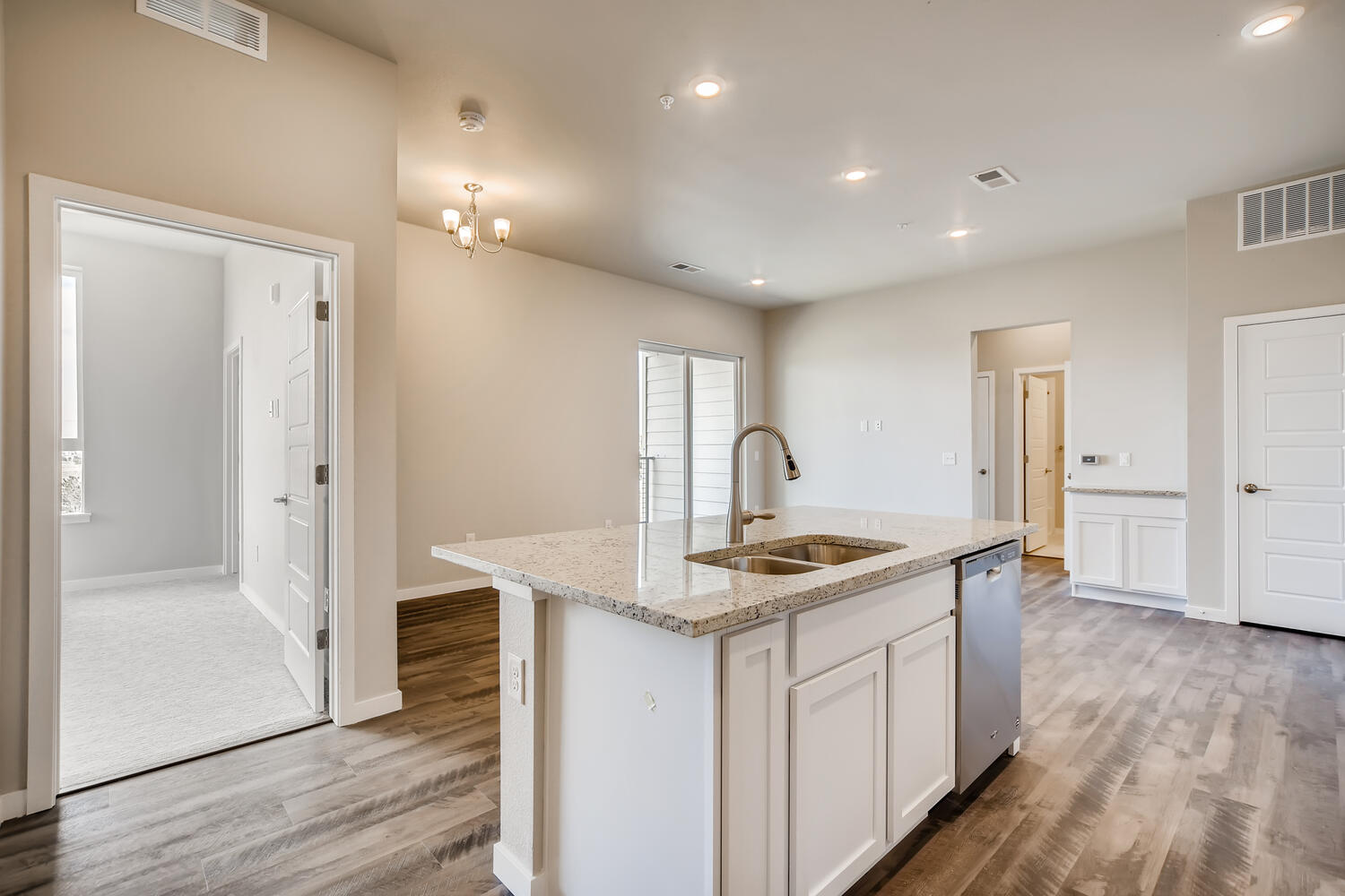 A kitchen with white cabinets.