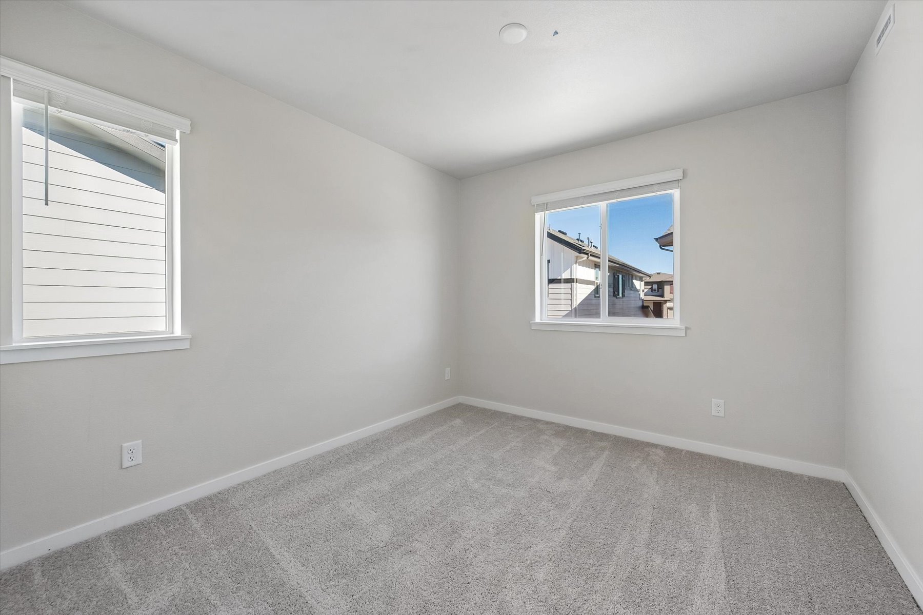 A room with a window and a carpet.