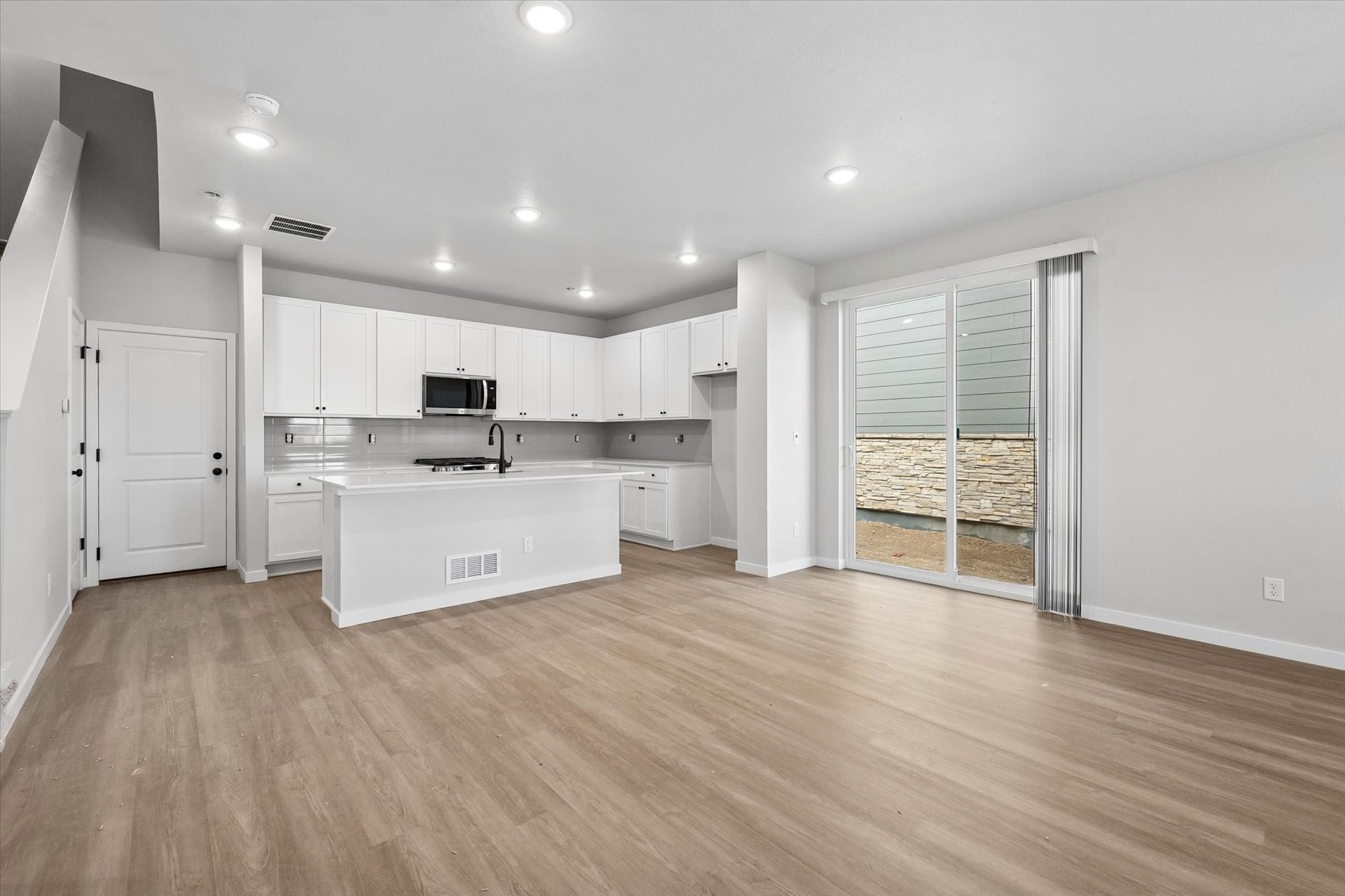 A large kitchen with white cabinets.
