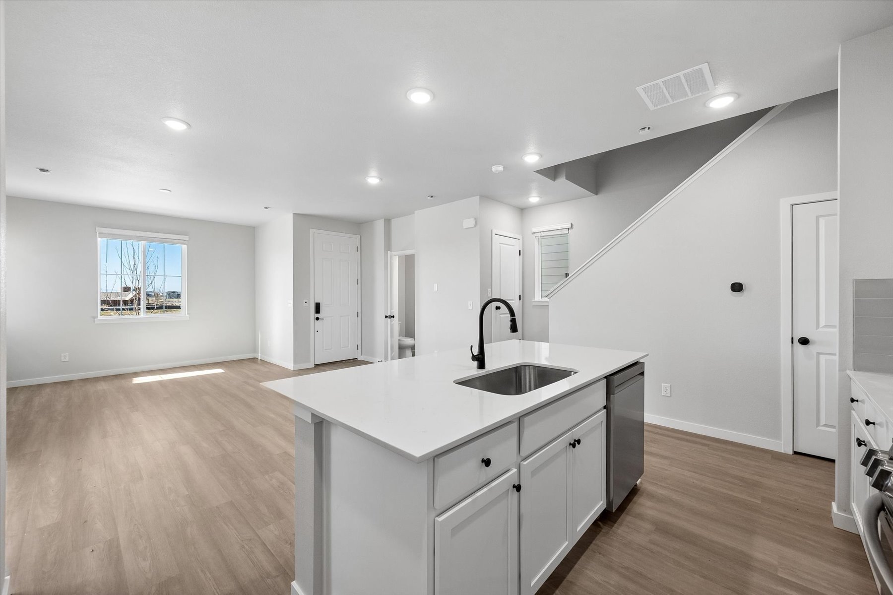 A kitchen with white cabinets.