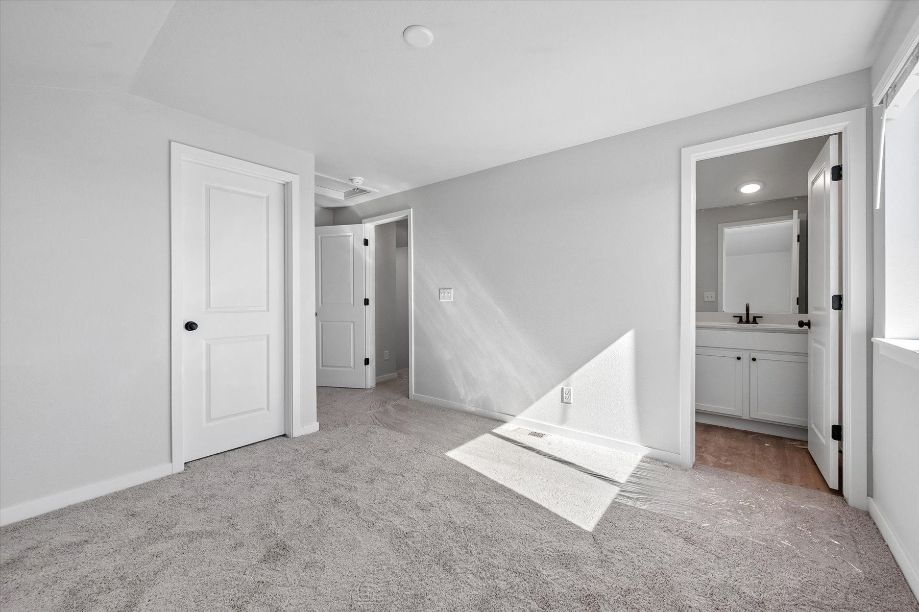 A bathroom with white walls.