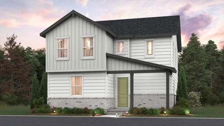 A white house with a green lawn.