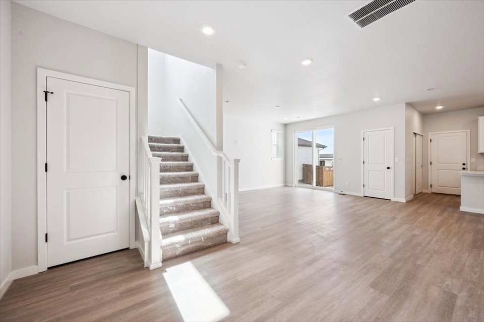 A large empty hall with white doors.