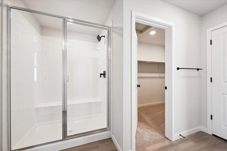 A shower with a glass door.