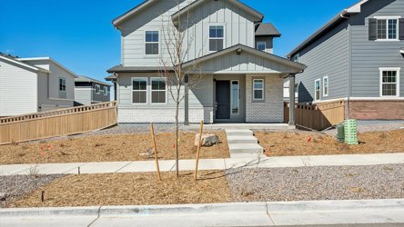 A house with a tree in front.
