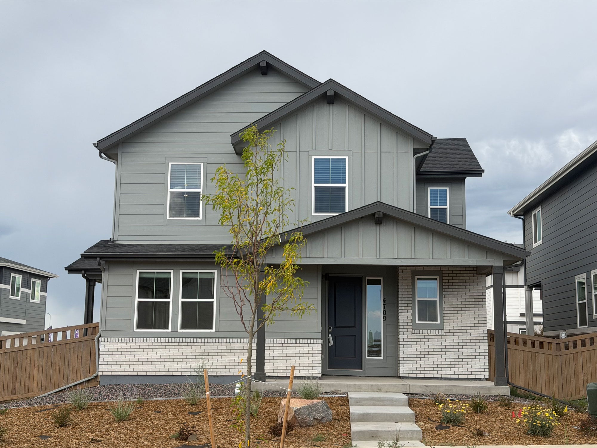 A house with a tree in the front.