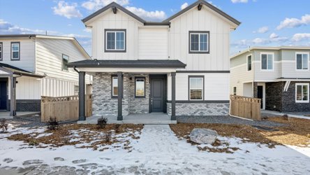 A house with a fence and snow.