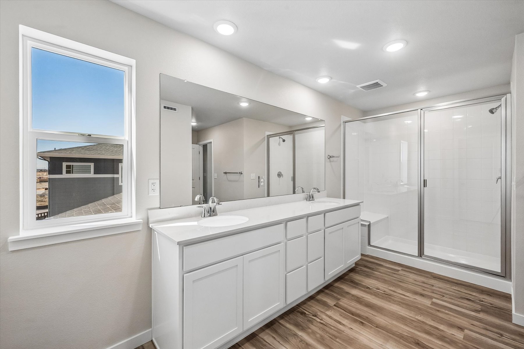 A bathroom with a large mirror.
