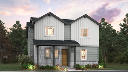 A grey house with trees in the background.