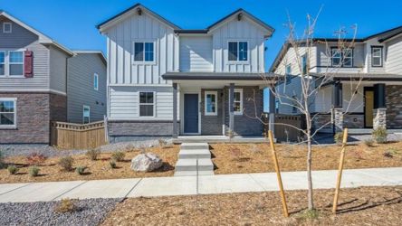 A house with a tree in front.