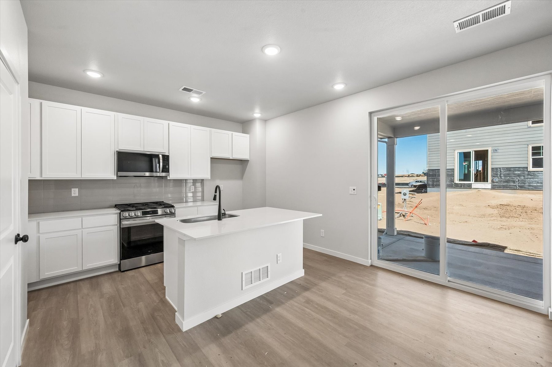 A kitchen with white cabinets.