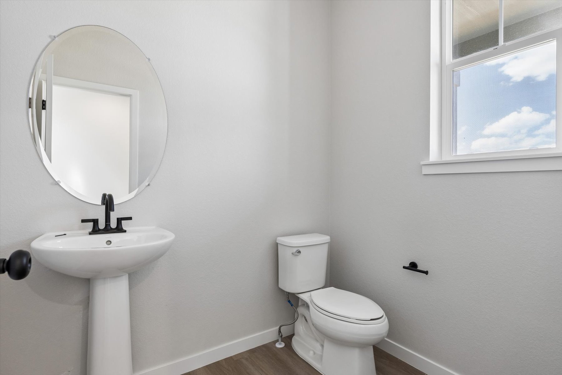 A bathroom with a toilet and sink.