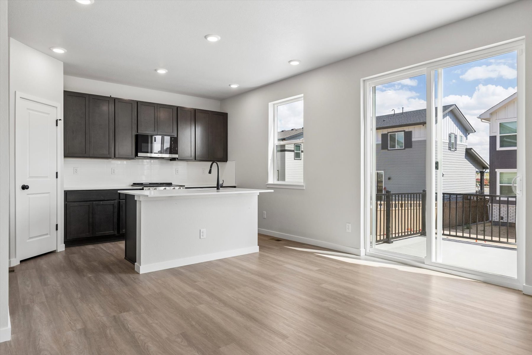 A kitchen with a wood floor.