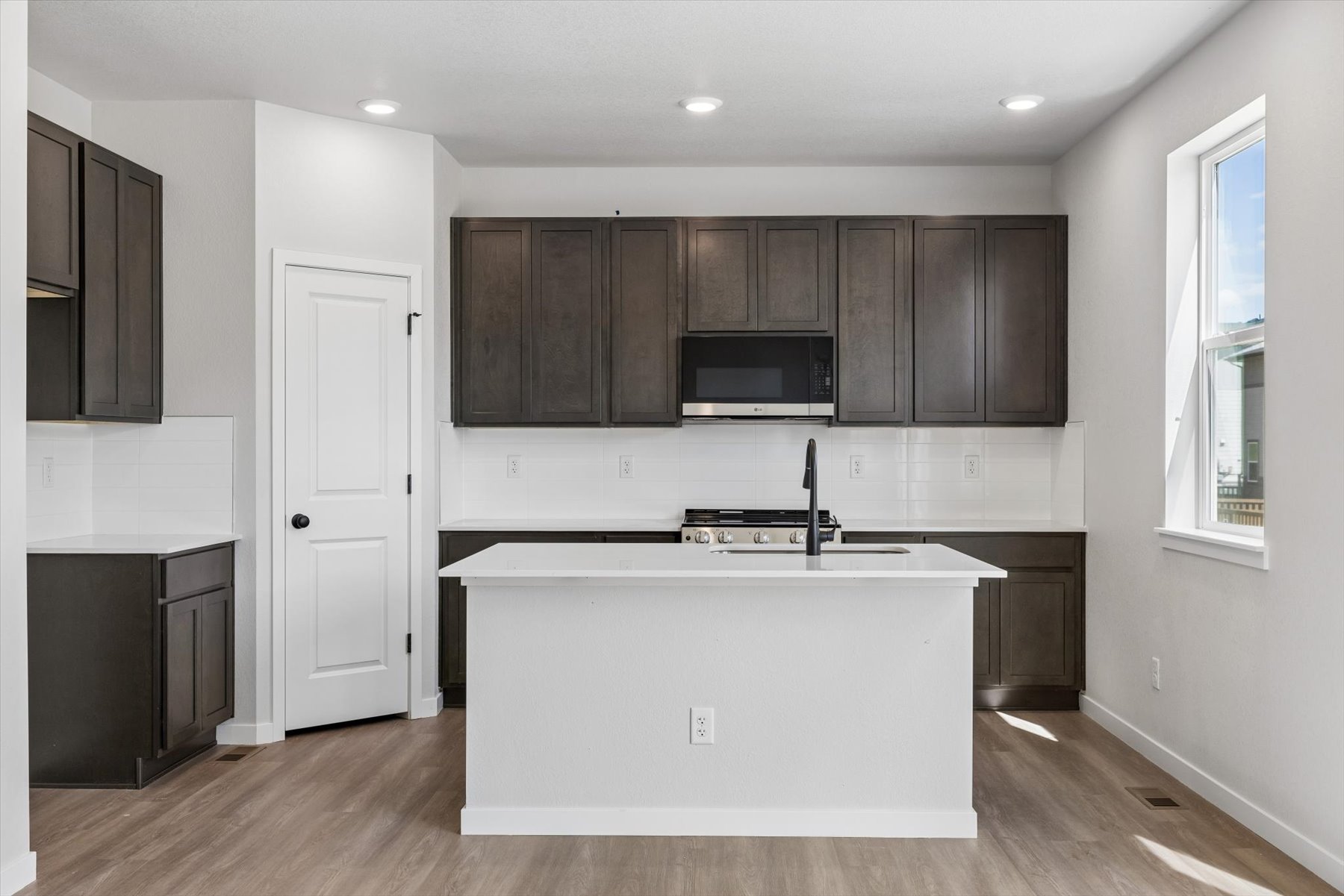 A kitchen with black cabinets.