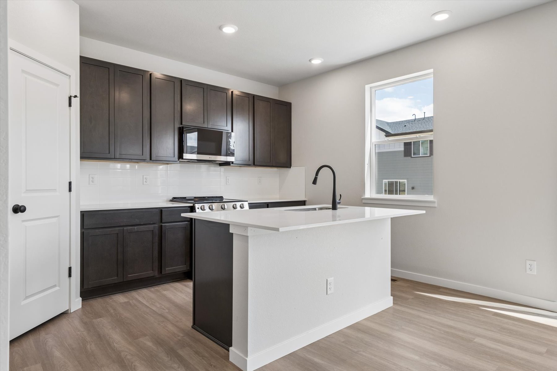 A kitchen with black cabinets.