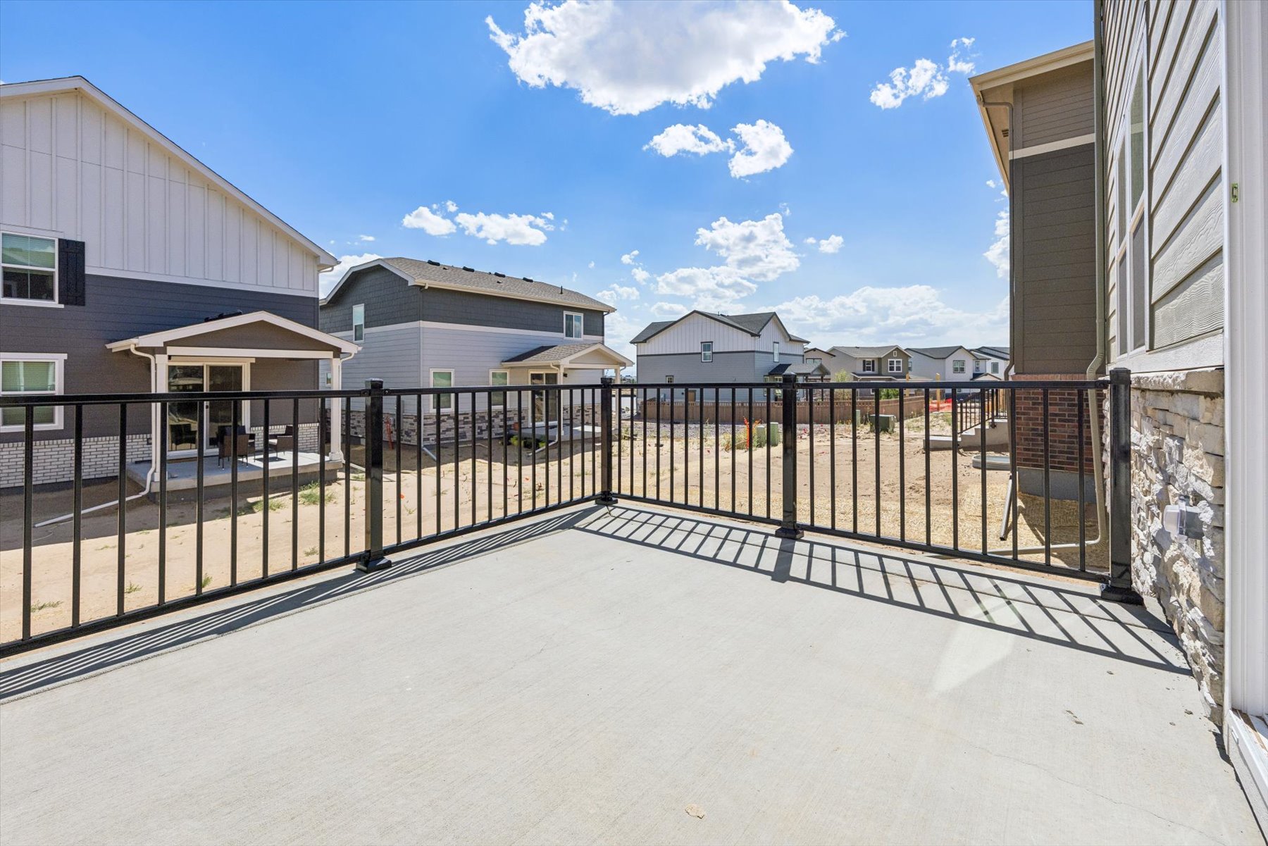 A fenced in area with buildings in the background.