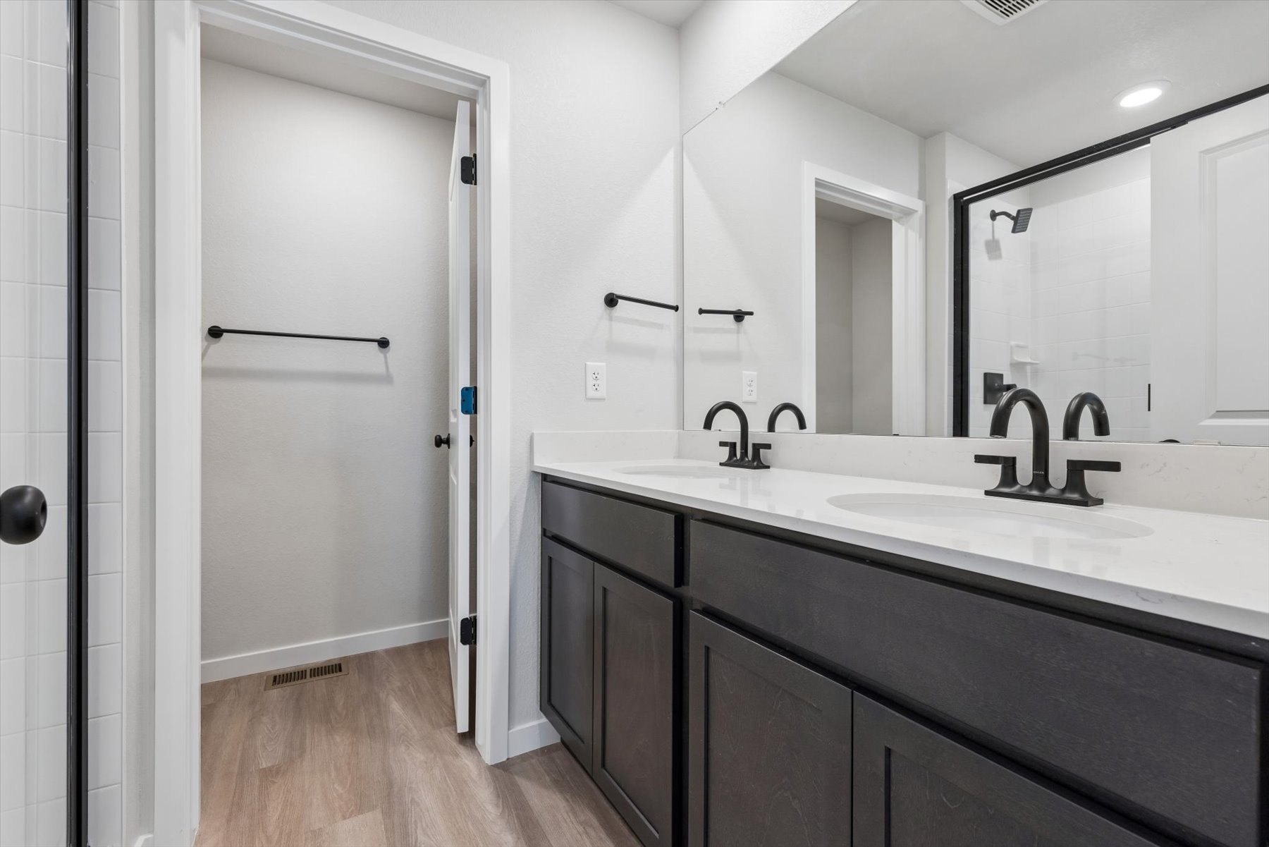 A bathroom with a sink and a shower unit.
