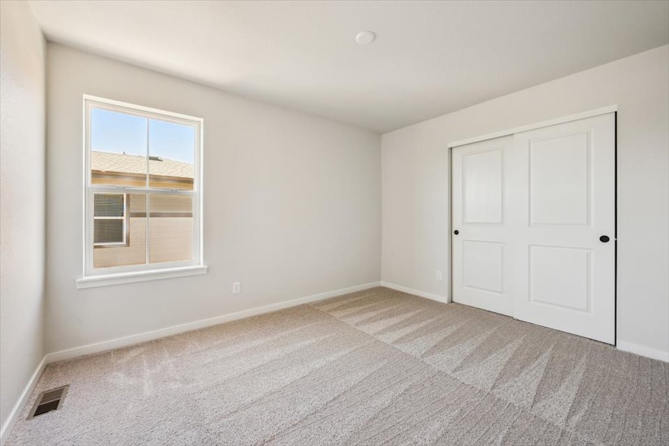 A room with white doors and a window.