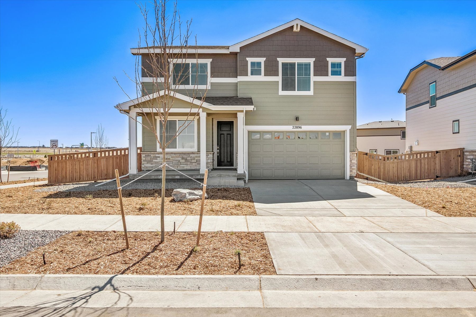 A house with a fence and a dirt yard.