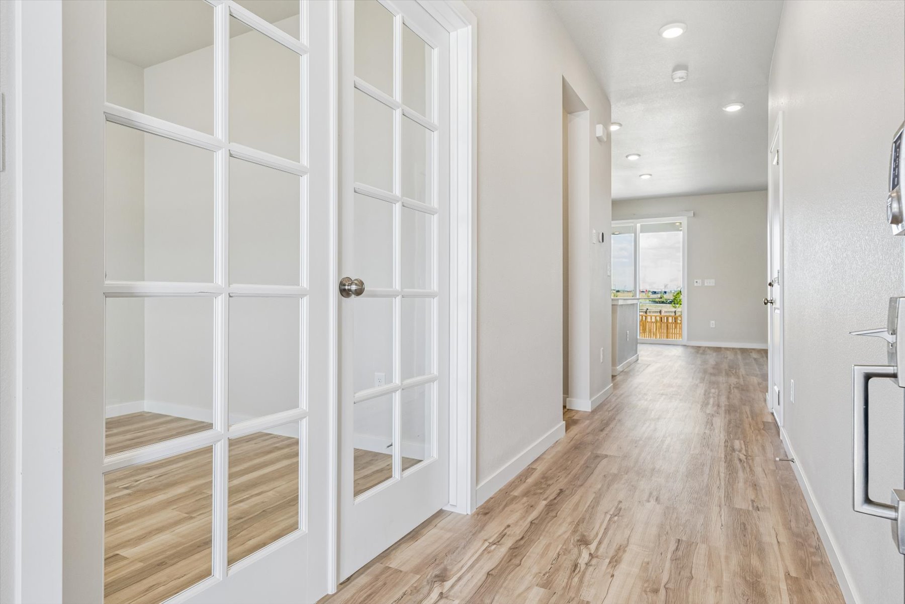 A hallway with white doors.