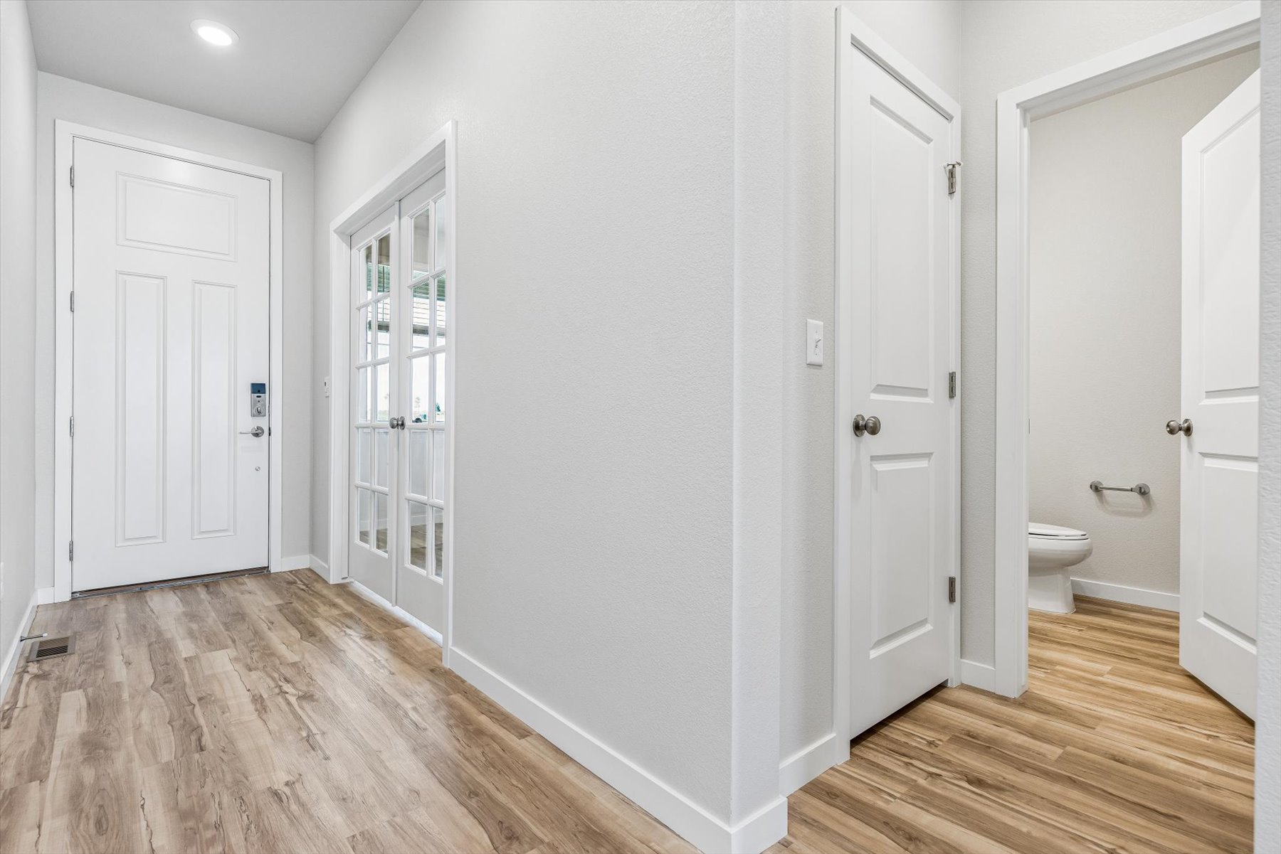 A bathroom with white doors.