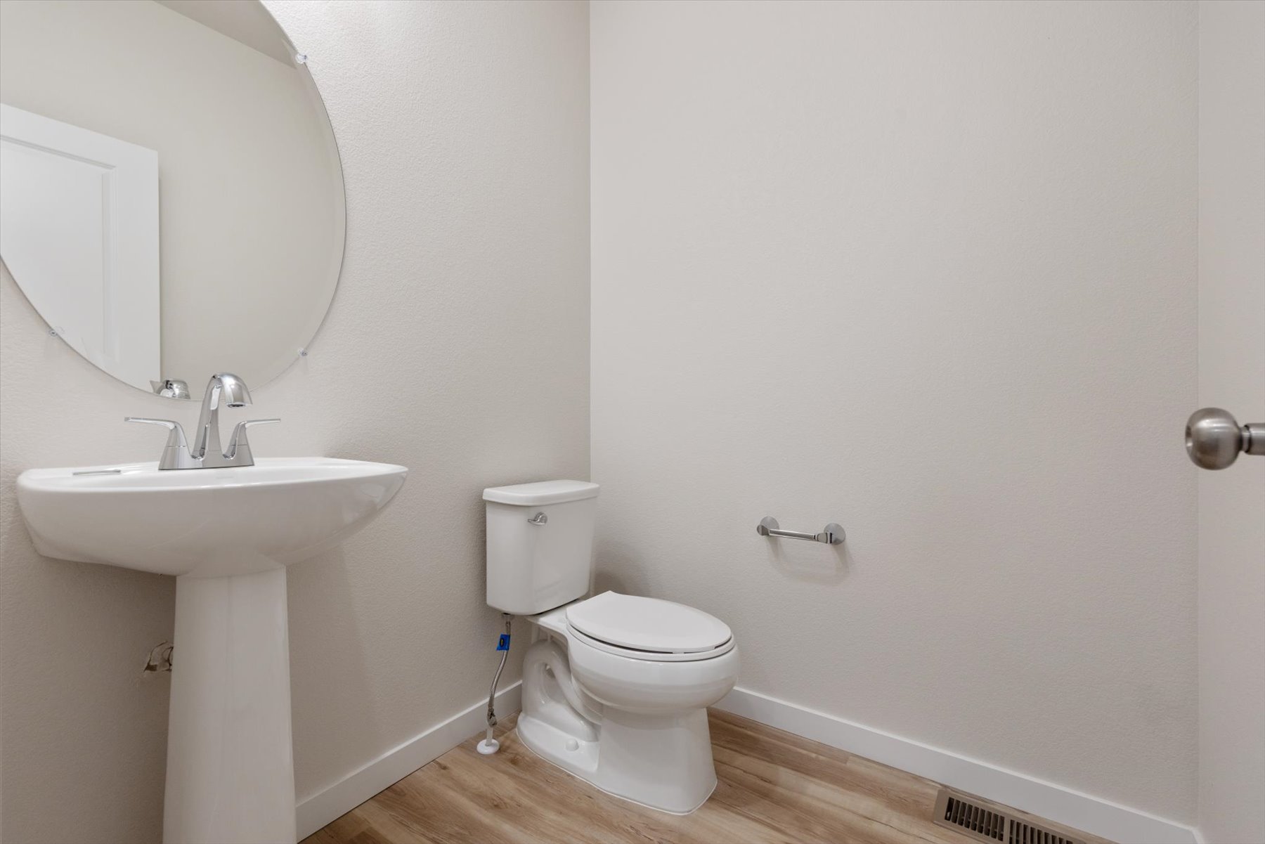 A bathroom with a toilet and sink.