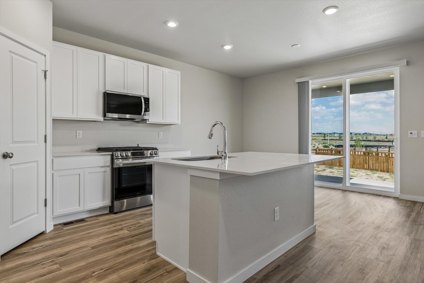 A kitchen with white cabinets.