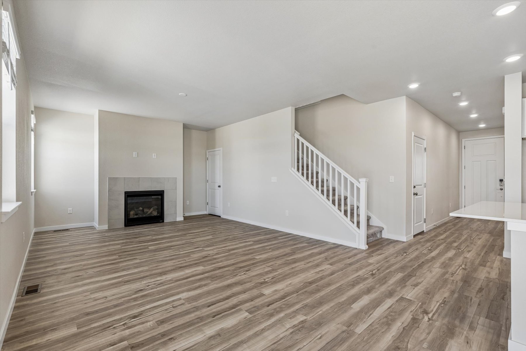 A large empty room with a fireplace.