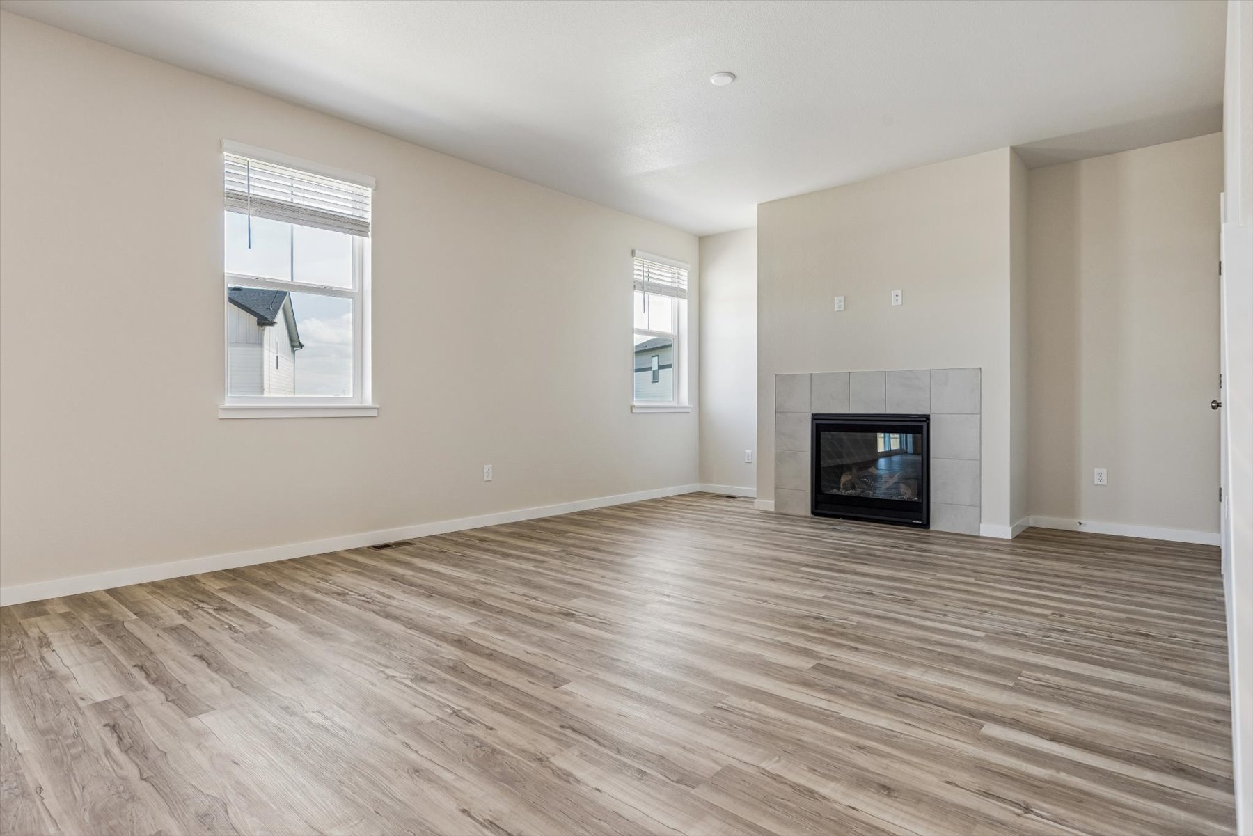 A room with a fireplace and a wood floor.
