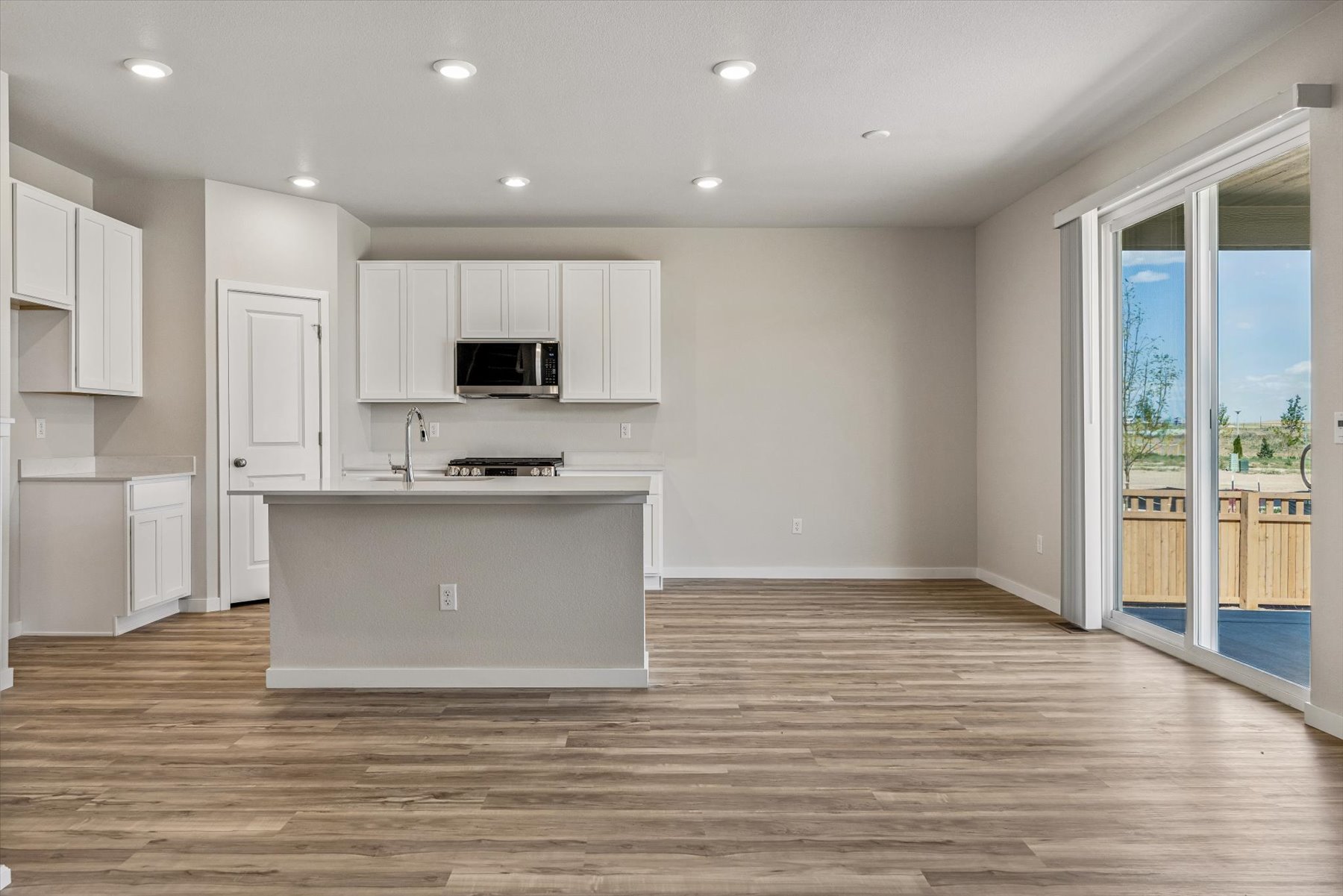 A kitchen with white cabinets.