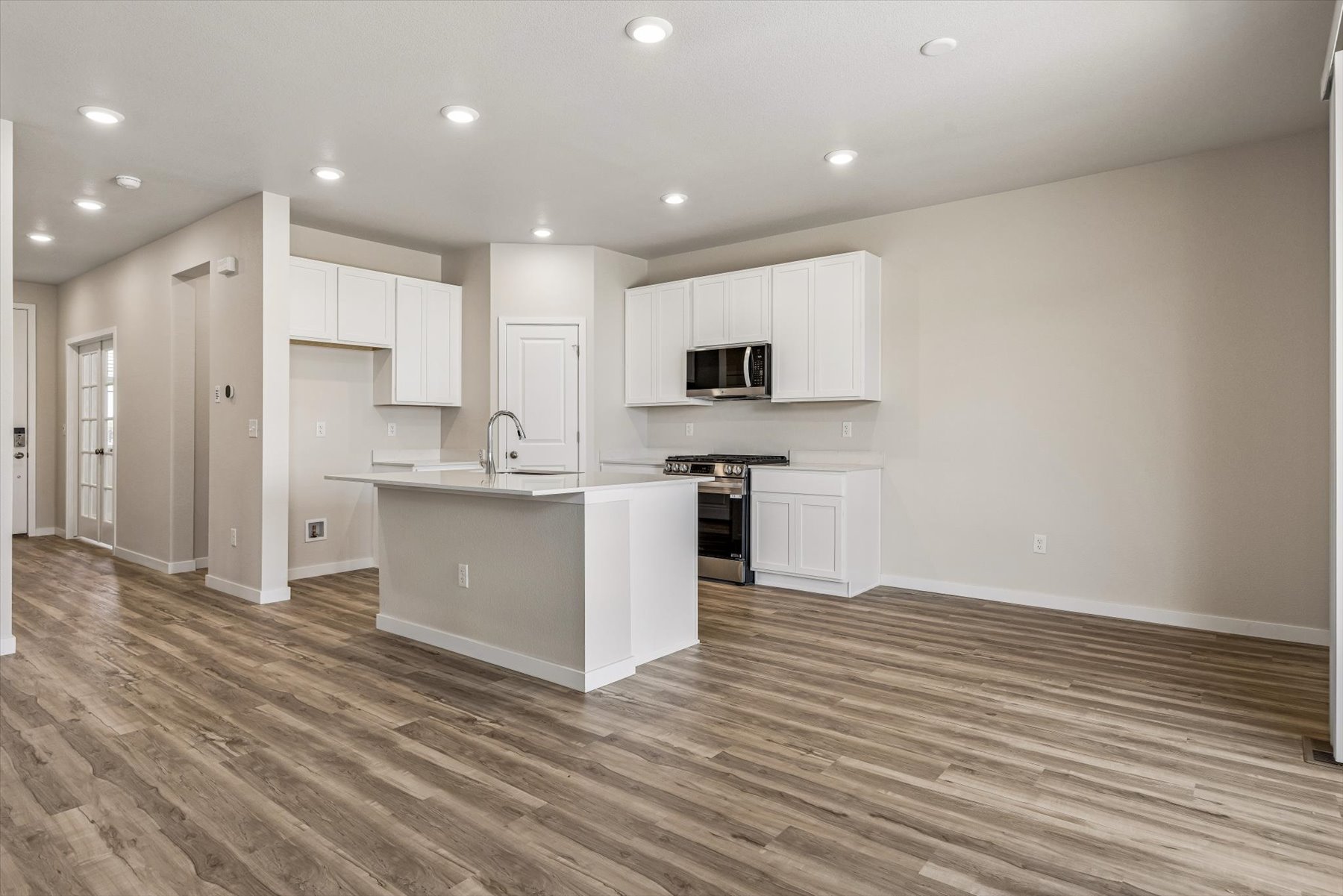 A kitchen with white cabinets.