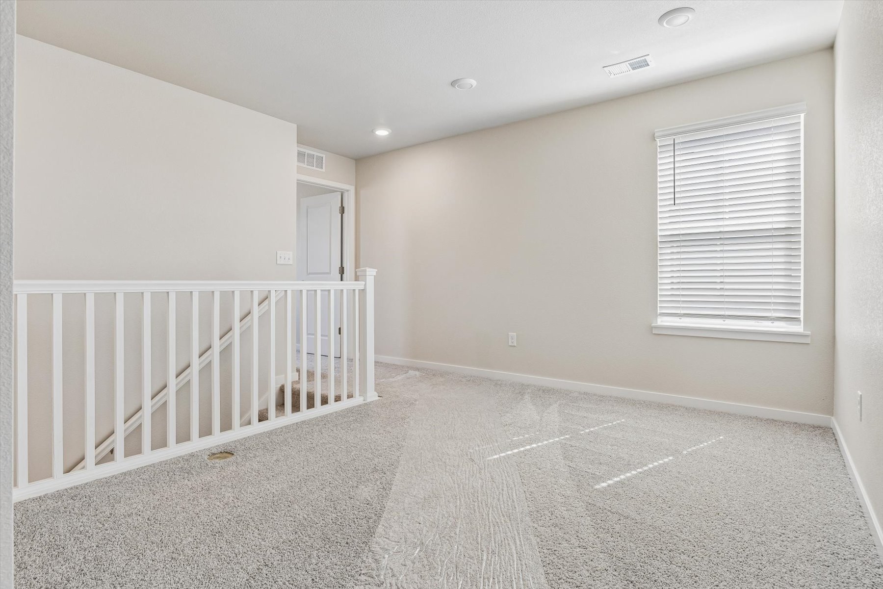 A room with a white railing and a white railing.