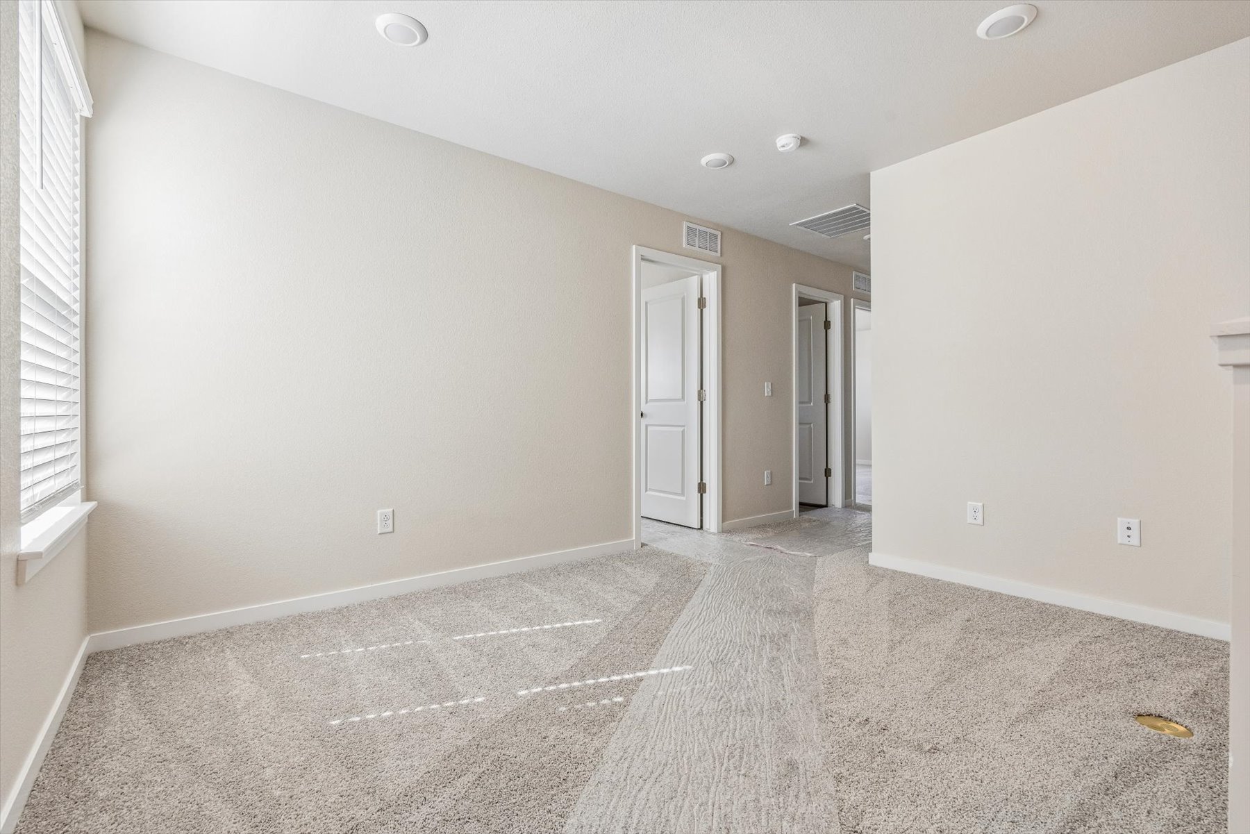A hallway with white walls.