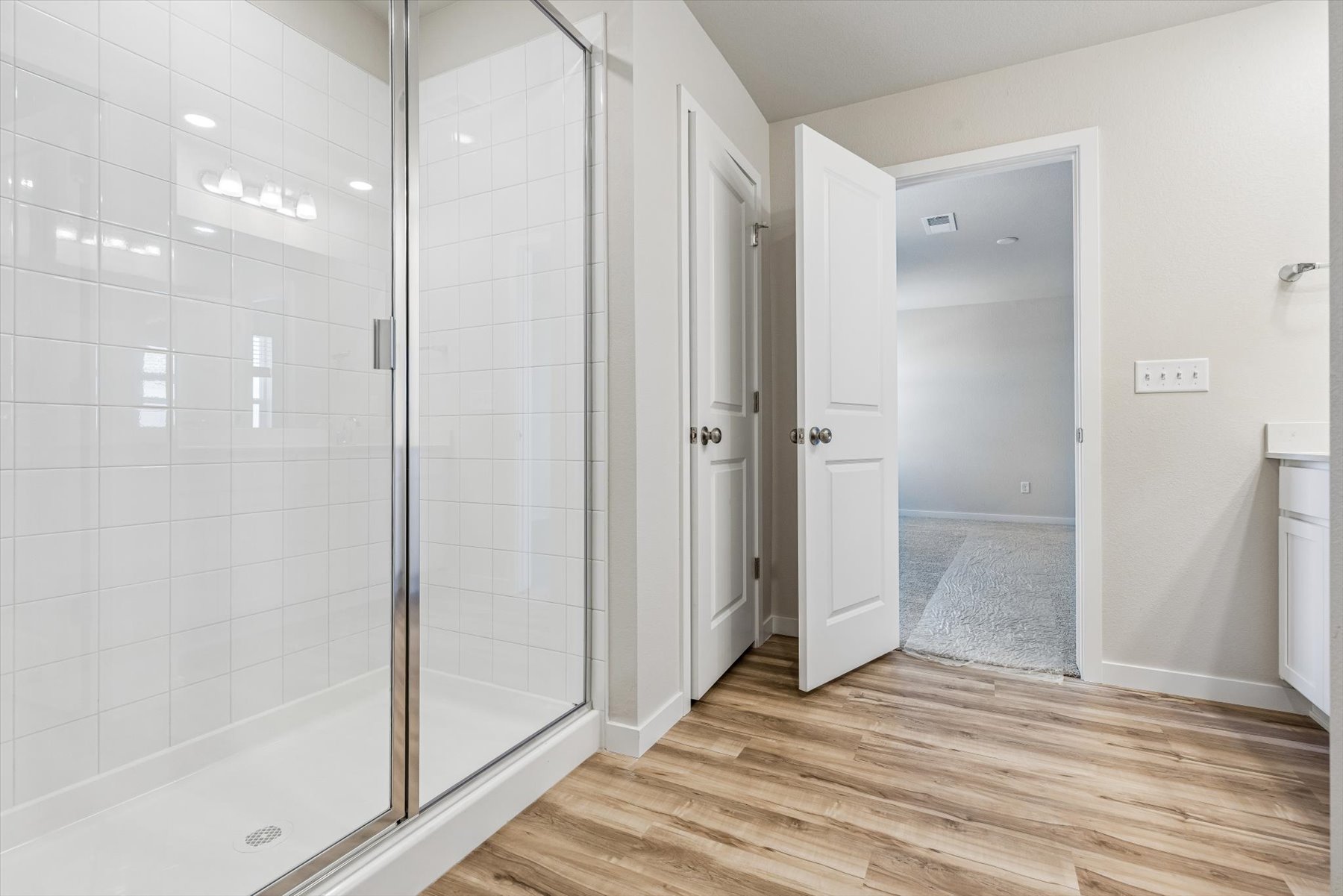 A room with white walls and a glass door.
