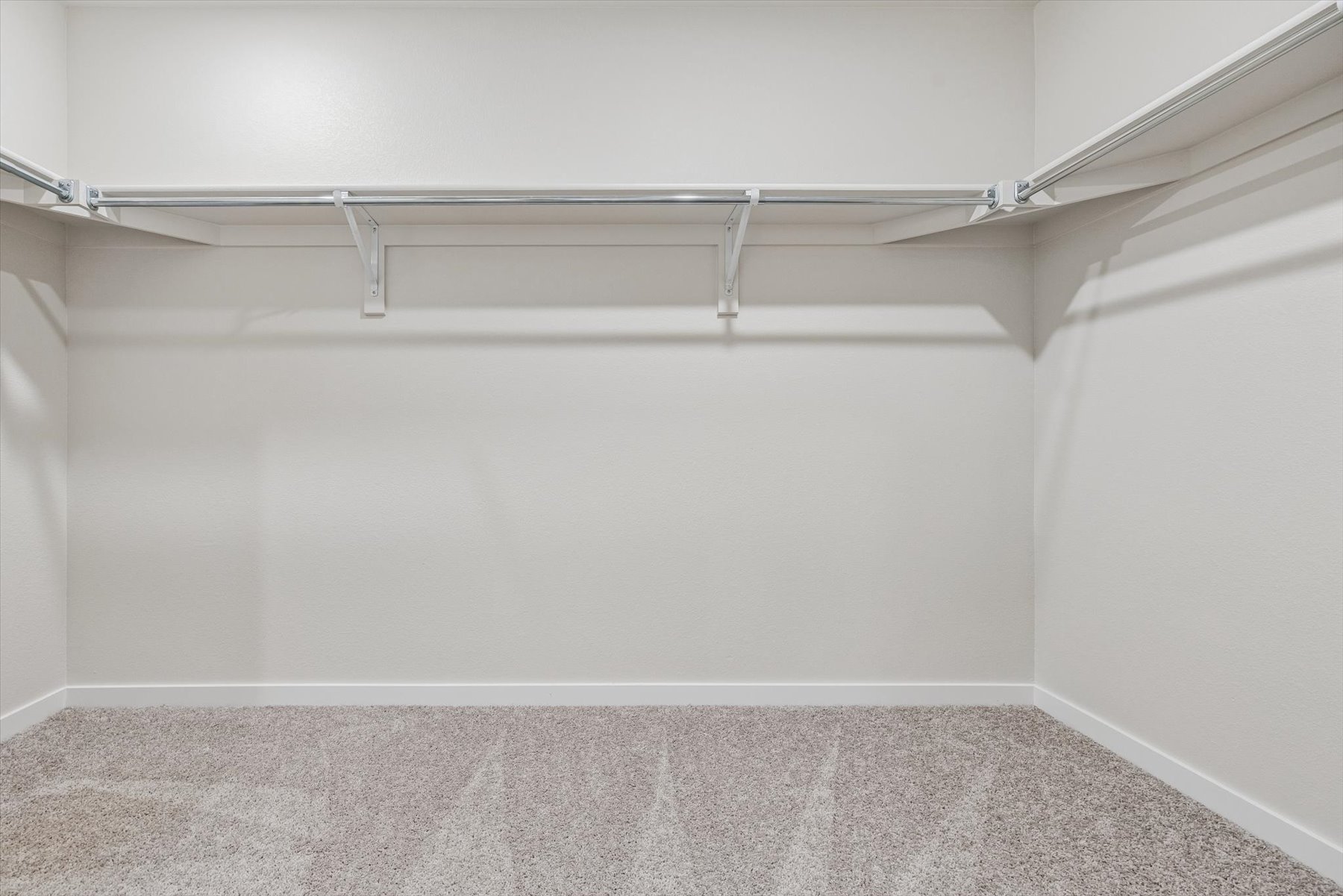 A metal bar on a white wall.