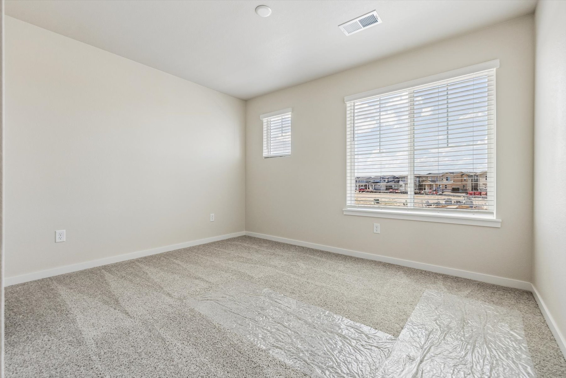 A room with a window and carpet.