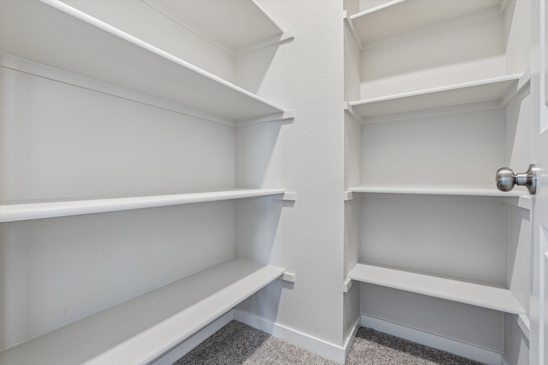 A white shelf with a light.