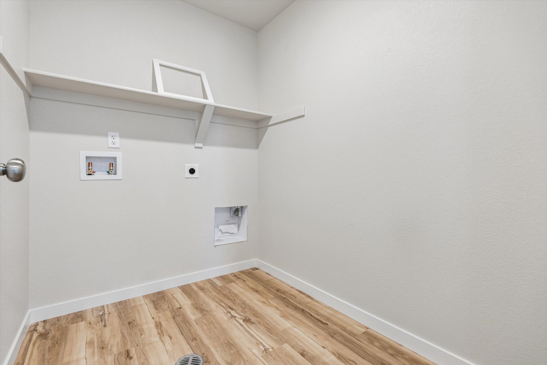 A room with a wood floor and white walls.