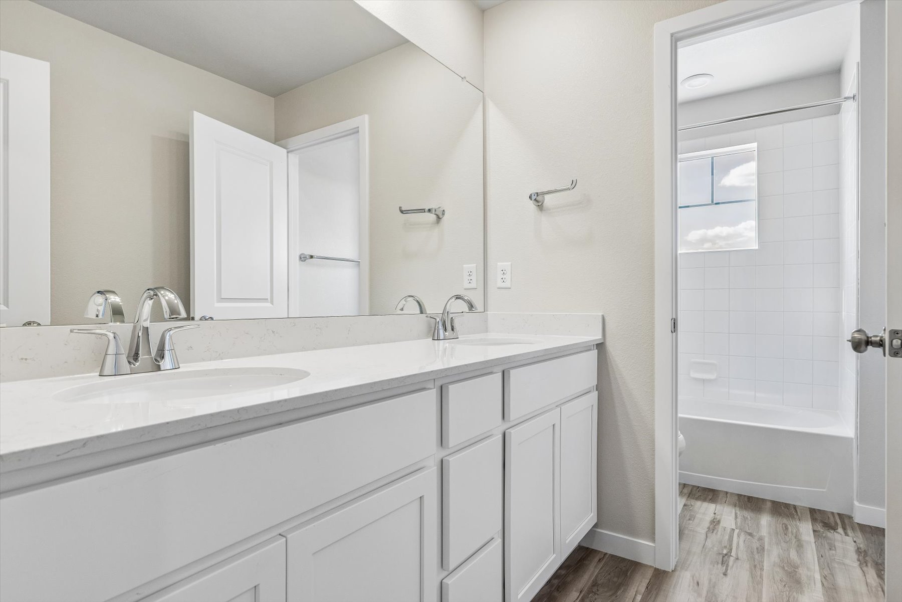 A bathroom with white cabinets.