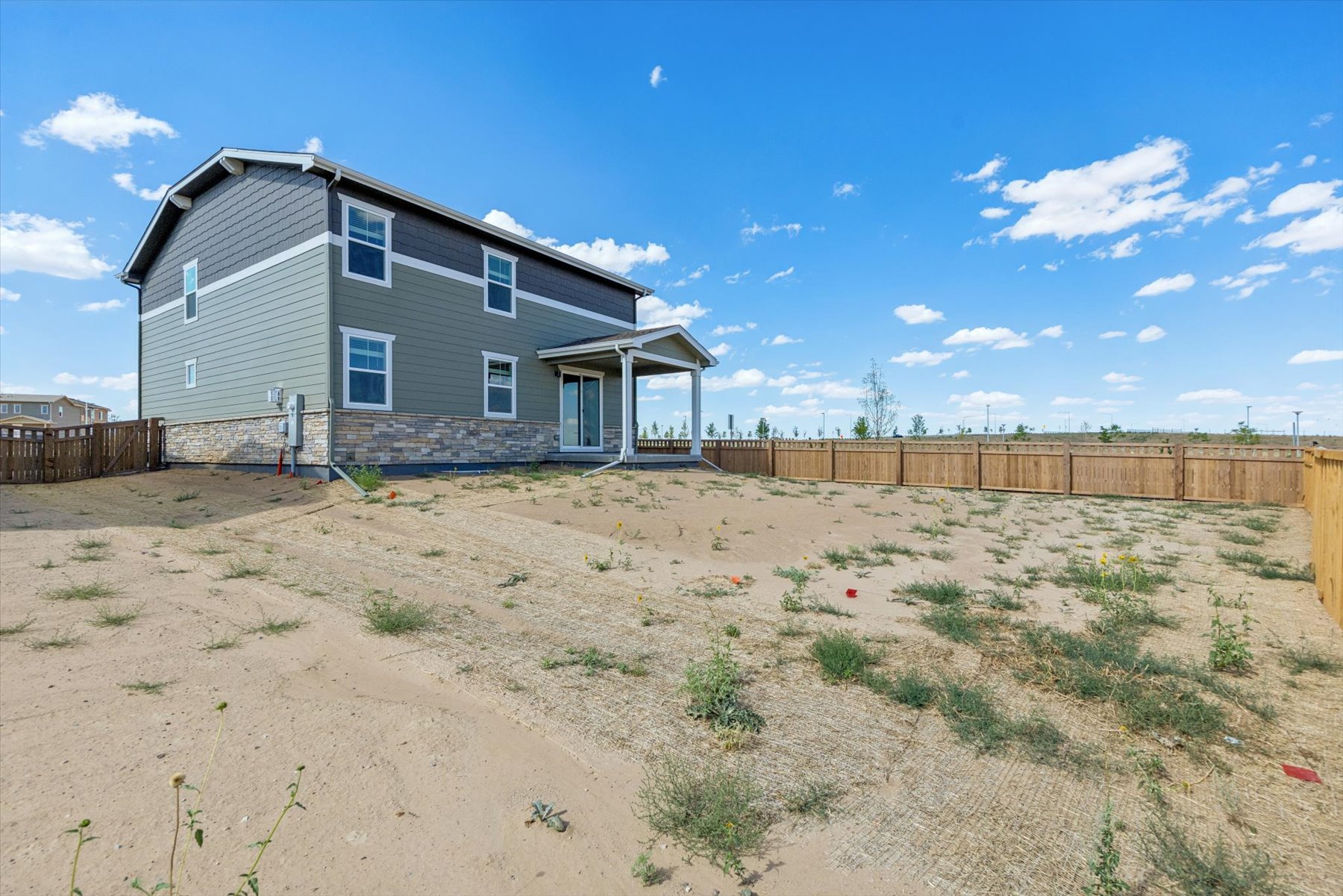 A house in a dirt field.