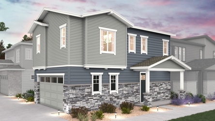 A grey house with a driveway.