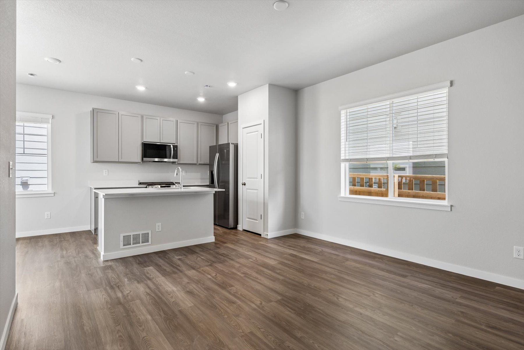 A kitchen with white cabinets.