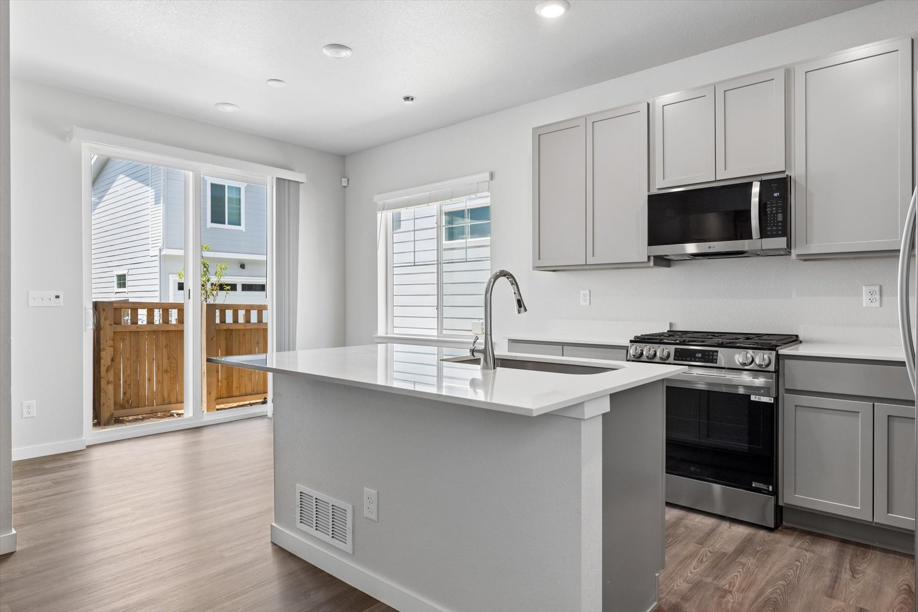 A kitchen with white cabinets.