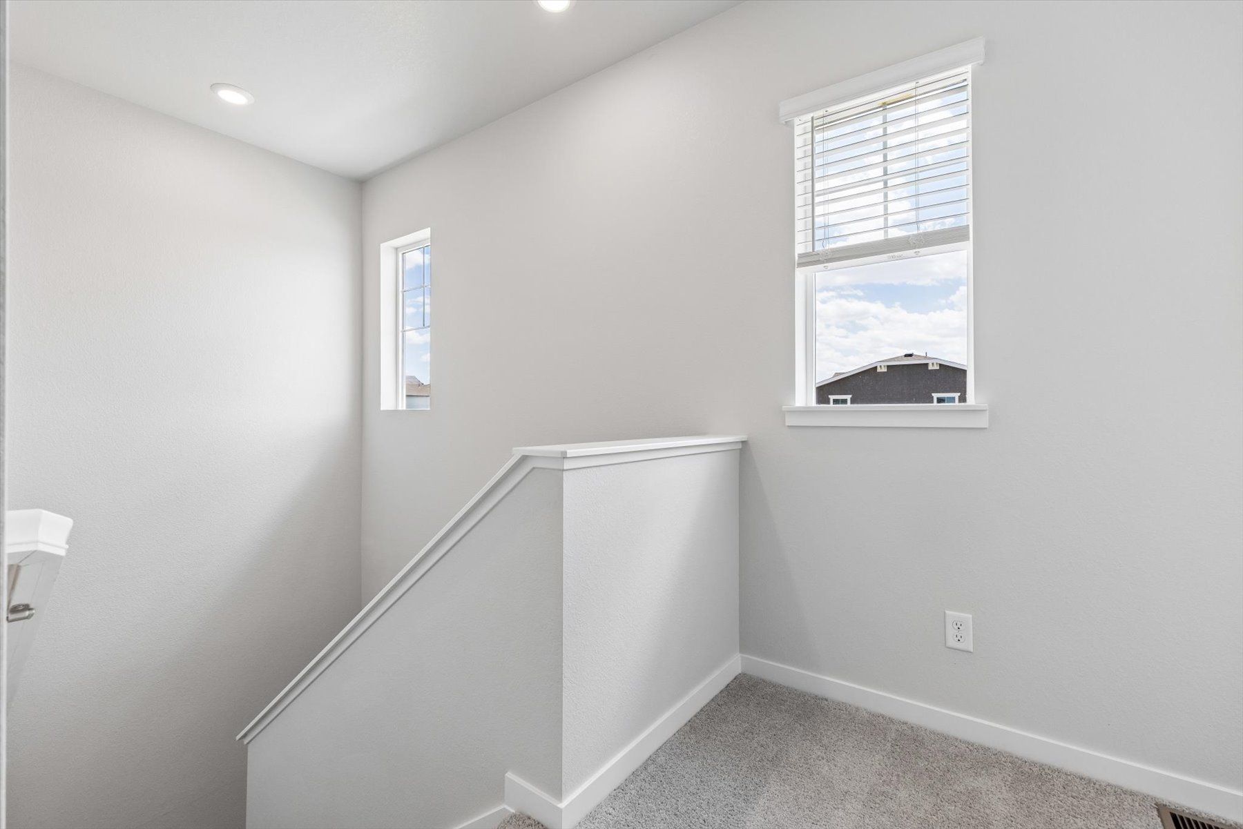 A room with a window and a white cabinet.