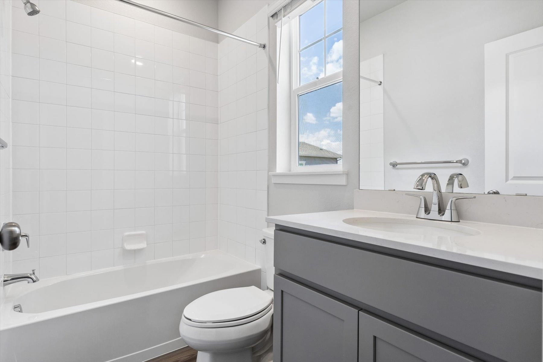 A bathroom with a tub sink and toilet.