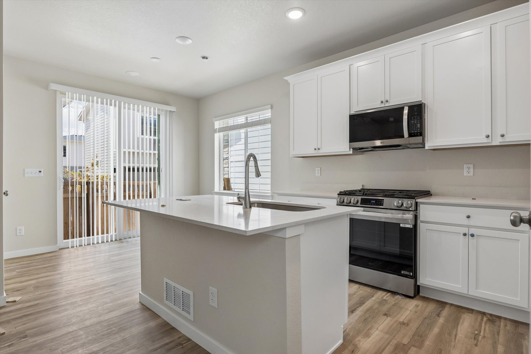 A kitchen with white cabinets.